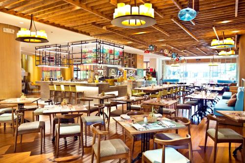 a restaurant with tables and chairs and a bar at Dusit Thani Manila in Manila
