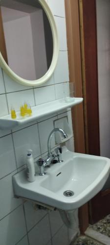 a white sink in a bathroom with a mirror at Fay's House in Mesagrós