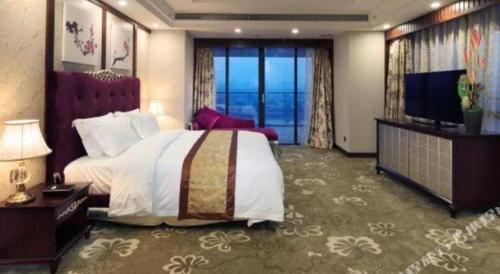 a hotel room with a bed and a television at SUN Yat-sen university Hotel and Conference Centre in Guangzhou