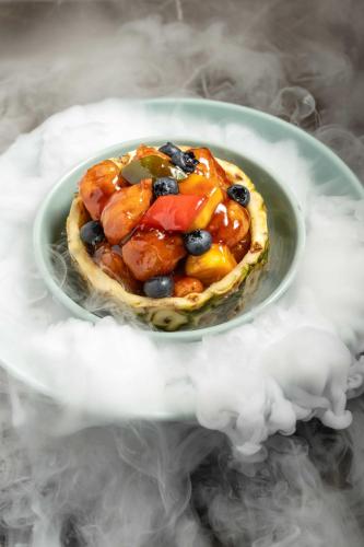 a plate of food with fruit on top of smoke at Hyatt Regency Hengqin-Free shuttle bus to Chimelong Ocean Kingdom & Hengqin Port in Zhuhai