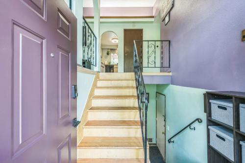 a hallway with a purple door and stairs at Portland Charming Home in Portland