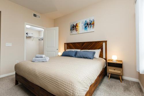 a bedroom with a large bed with blue pillows at Stunning 2 bedroom near by The Grove in Los Angeles