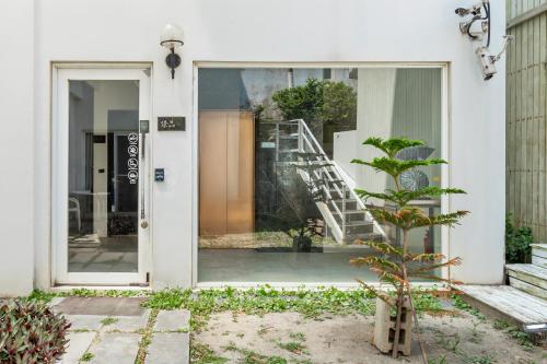 a glass door of a building with a staircase outside at 白水木民宿 in Eluan