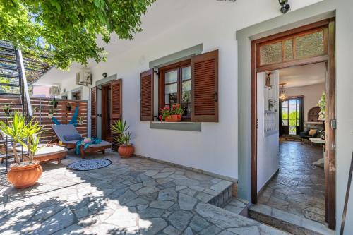 a porch of a house with a patio at Efcharis house Skopelos in Neo Klima