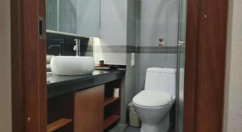 a bathroom with a toilet and a sink at James Joyce Coffetel Xian Dayanta Metro Station Branch in Xi'an