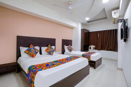 a hotel room with two beds and a television at FabHotel Kamran Residency - Nr LBS Marg in Mumbai