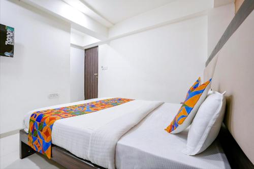 a bedroom with a bed in a white room at FabHotel Kamran Residency - Nr LBS Marg in Mumbai