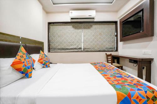 a bedroom with a white bed and a window at FabHotel Kamran Residency - Nr LBS Marg in Mumbai