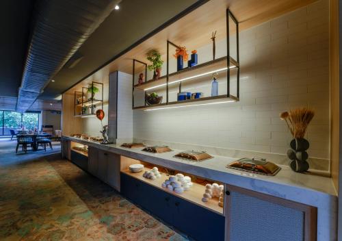 a room with a counter with vases on it at TGI Oberon in Bengaluru