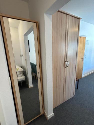 a room with a mirror and a closet at Hotel Haus Schwan Köln in Cologne