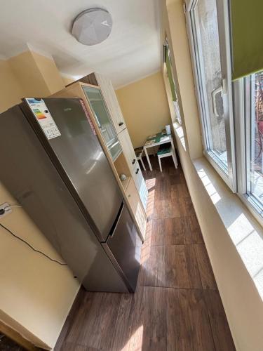 a kitchen with a stainless steel refrigerator in a room at Ferienwohnung Violetta in Băile Herculane