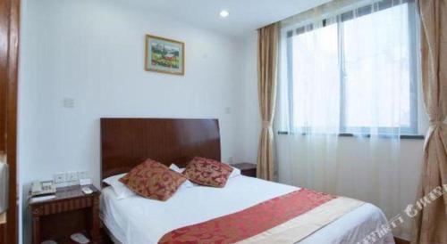 a hotel room with a bed and a window at Shijia Inn On the Bund in Shanghai