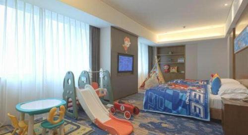 a childs bedroom with a bed and play equipment at Wuhan Gleetour Hotel in Wuhan