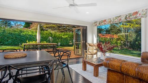 a living room with a couch and a table at Glenluce Mountain Cottage Circa 1896 in Wentworth Falls