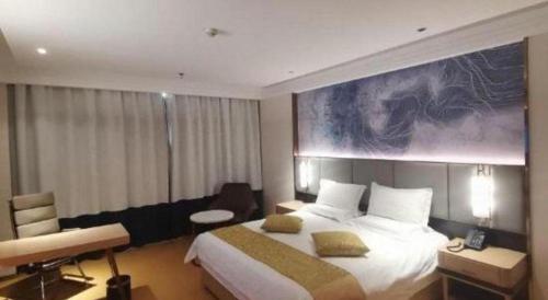 a hotel room with a large bed and a desk at GreenTree Inn Taiyuan PinGYAng Road Business Hotel in Taiyuan