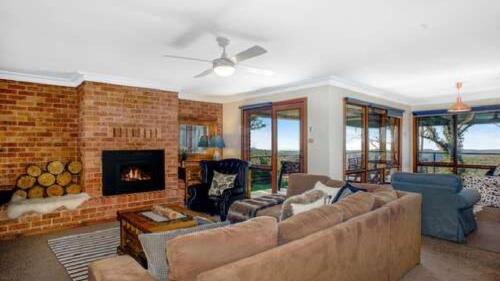 a living room with a couch and a fireplace at Hat Hill Hideaway Amazing Valley Views in Blackheath
