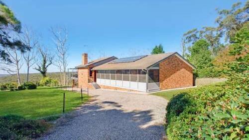 a large brick house with a roof at Hat Hill Hideaway Amazing Valley Views in Blackheath
