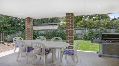 a white table and chairs on a patio at Refresham Katoomba South in Katoomba