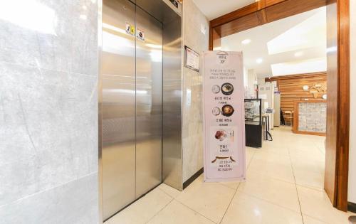 a elevator in a building with a sign on it at Joy Hotel in Jeju