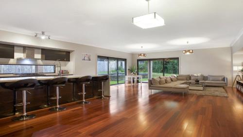 a kitchen and living room with a couch and a table at The Cherry Blossom Blackheath in Blackheath