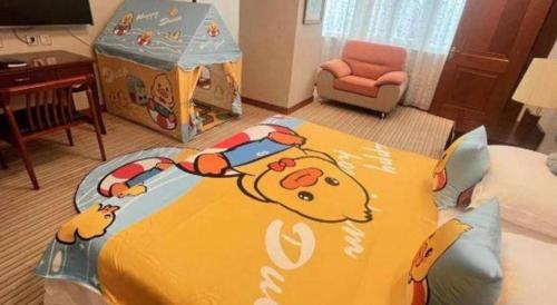 a room with a bed with a hello kitty blanket at Shaanxi Business Hotel in Shanghai