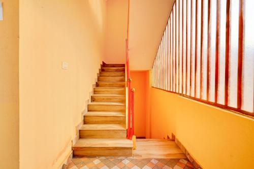 a staircase in a building with a large window at Super Hotel O Ramachandrapuram formerly known Nataraja Boarding & Lodging in Bengaluru