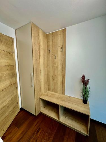 a room with a wooden bench and a door at Nest 51 - Stylish Flat near Wörthersee in Klagenfurt