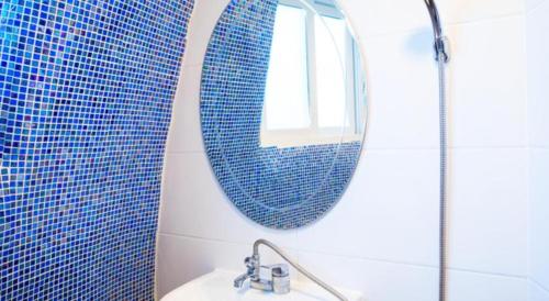 a bathroom with a mirror and a sink at All That Water Pension in Gapyeong