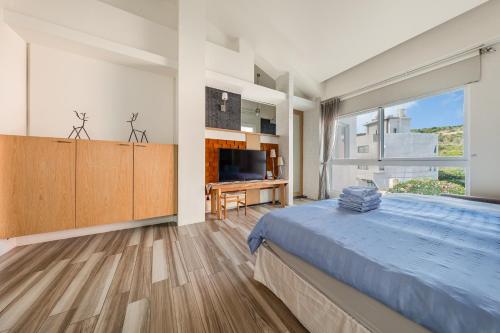 a bedroom with a large bed and a large window at 白水木民宿 in Eluan