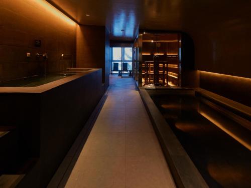 a long hallway in a restaurant with a bar at FAV LUX Sapporo Susukino in Sapporo