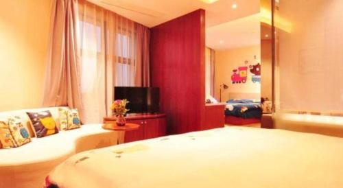 a bedroom with a bed and a tv in a room at Hangzhou Berman Hotel in Hangzhou