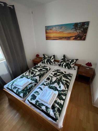 a bedroom with a bed with a bedspread and pillows at Apartman Viki in Krk