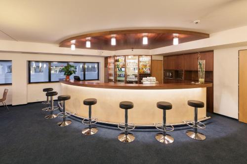 a lobby with a bar with stools at Hotel Port Doksy in Staré Splavy