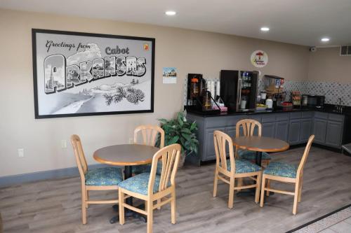 a waiting room with two tables and chairs and a counter at Super 8 by Wyndham Cabot in Cabot