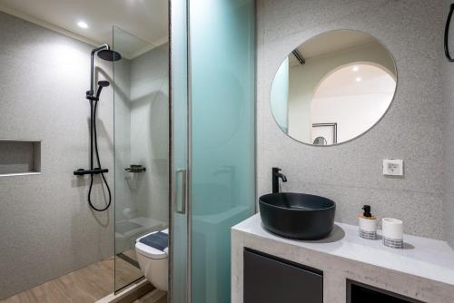 a bathroom with a sink and a shower at Cavrõs apartments in Khóra Sfakíon