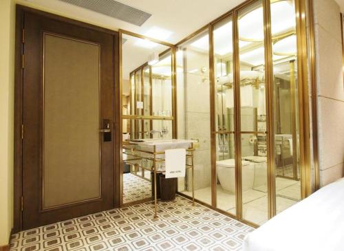 a bathroom with a sink and a toilet at King's Hotel in Hong Kong