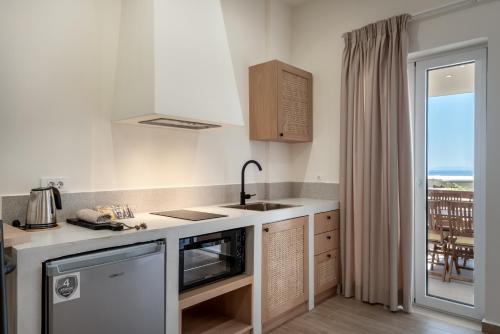 a kitchen with a sink and a counter top at Cavrõs apartments in Khóra Sfakíon