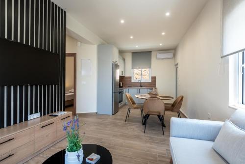 a living room with a couch and a table at Cavrõs apartments in Khóra Sfakíon