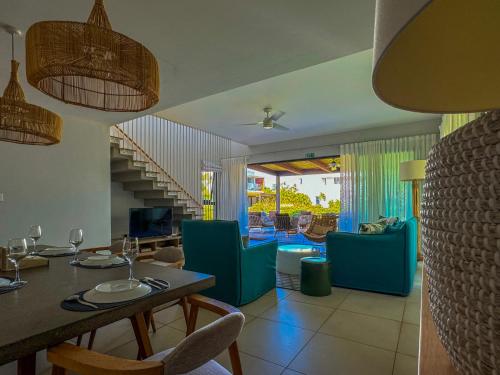 a dining room with a table and some chairs at Manta Cove by Horizon Holidays in Tamarin
