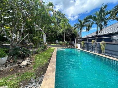 a swimming pool in front of a house at V198 Quiet 2BR Villa with Garden & Private Pool in Ban Khlong Mae Nam
