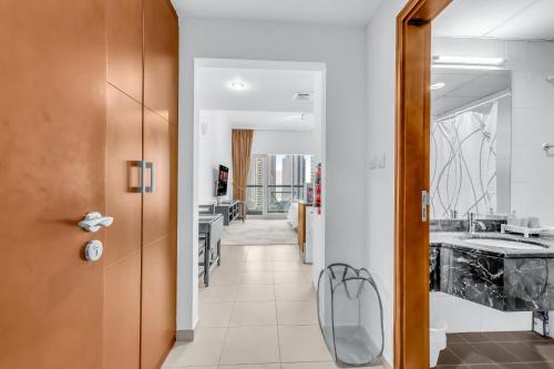 a hallway leading to a kitchen with a sink at Burj Al Nujoom Luxurious Apartment Downtown Dubai Mall in Dubai