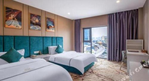a hotel room with two beds and a window at Chengdu Huadu Times Hotel in Chengdu