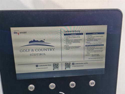 a computer screen with a sign on top of it at The Lodge Sporthotel - Golfclub Eppan in Appiano sulla Strada del Vino