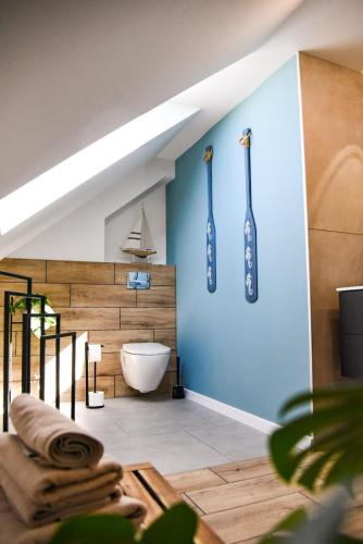 a bathroom with a white tub and tooth brushes on the wall at Vrij Ferienhaus in Zastań