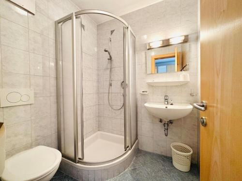 a bathroom with a shower and a toilet and a sink at Apartment in Fügen near Ski Lift in Fügen
