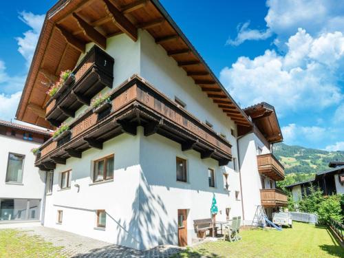 a white building with a wooden roof at Apartment in Fügen near Ski Lift in Fügen