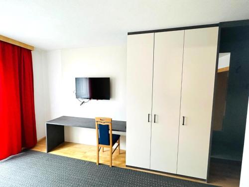 a room with a desk and a red curtain at Apartment in Fügen near Ski Lift in Fügen