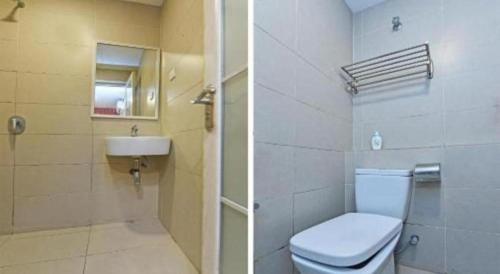 a bathroom with a toilet and a sink at Capital O 90574 Hotel Glo in Kuala Lumpur