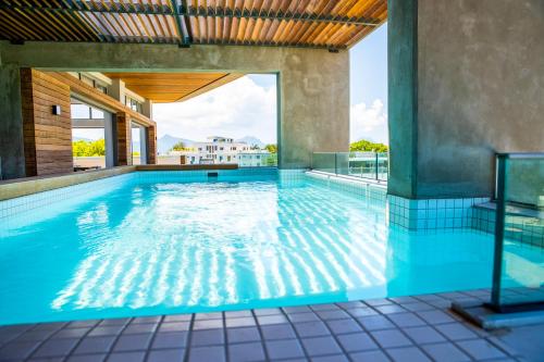 an indoor swimming pool with blue water at Manta Cove by Horizon Holidays in Tamarin