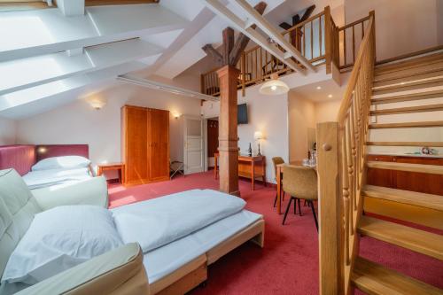 a bedroom with a bunk bed and a staircase at Hotel Raffaello Prague in Prague